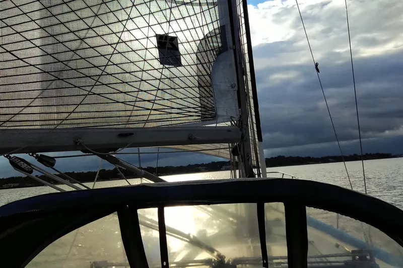 Slide: The Image of Sailing on a 1984 C&C 35 MK III yacht at sunset, with dramatic sky and calm waters. - 11
