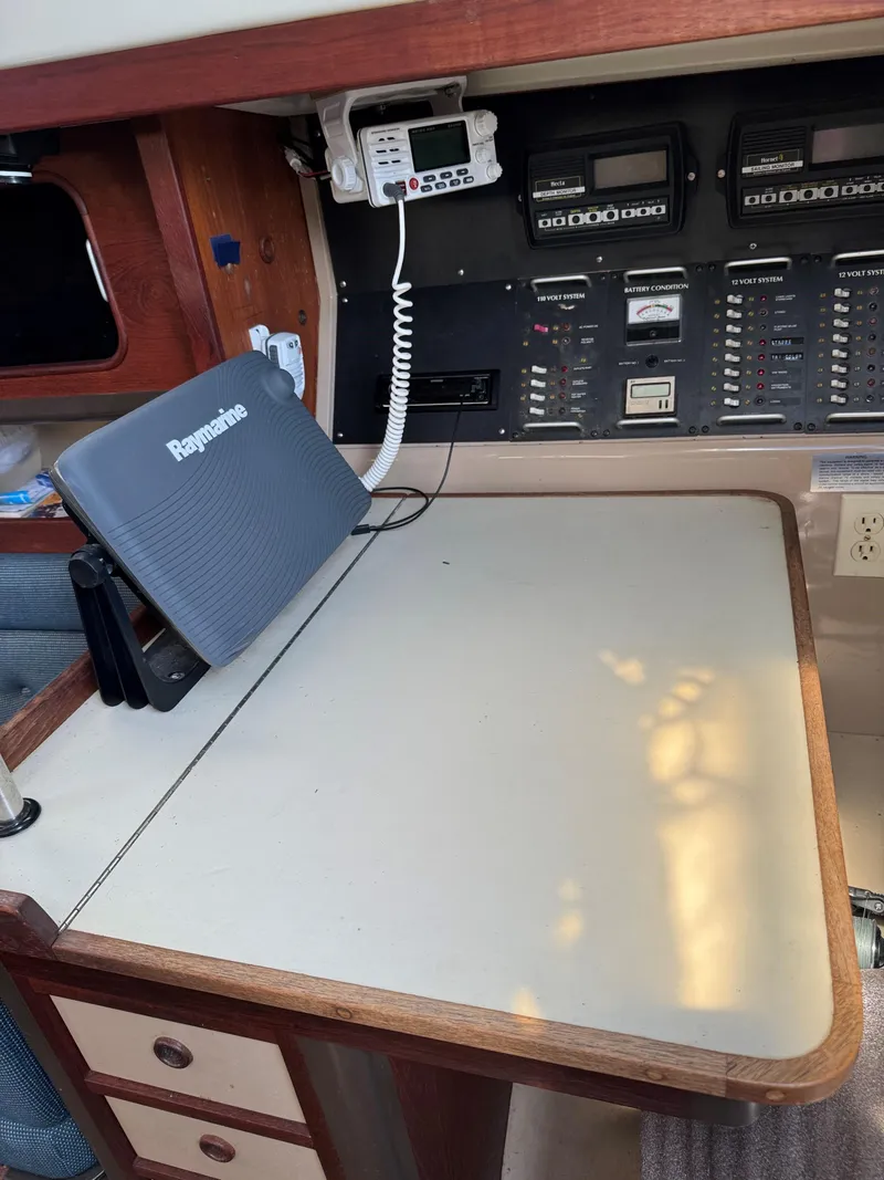 Slide: The Image of Navigation station inside 1984 C&C 35 MK III sailboat with communication equipment. - 14