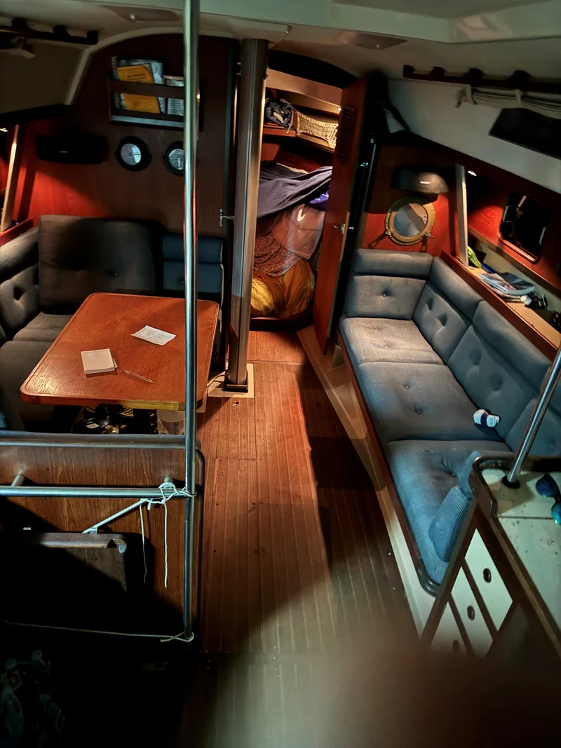 Slide: The Image of Interior of 1984 C&C 35 MK III sailboat with cozy seating and wooden accents. - 16