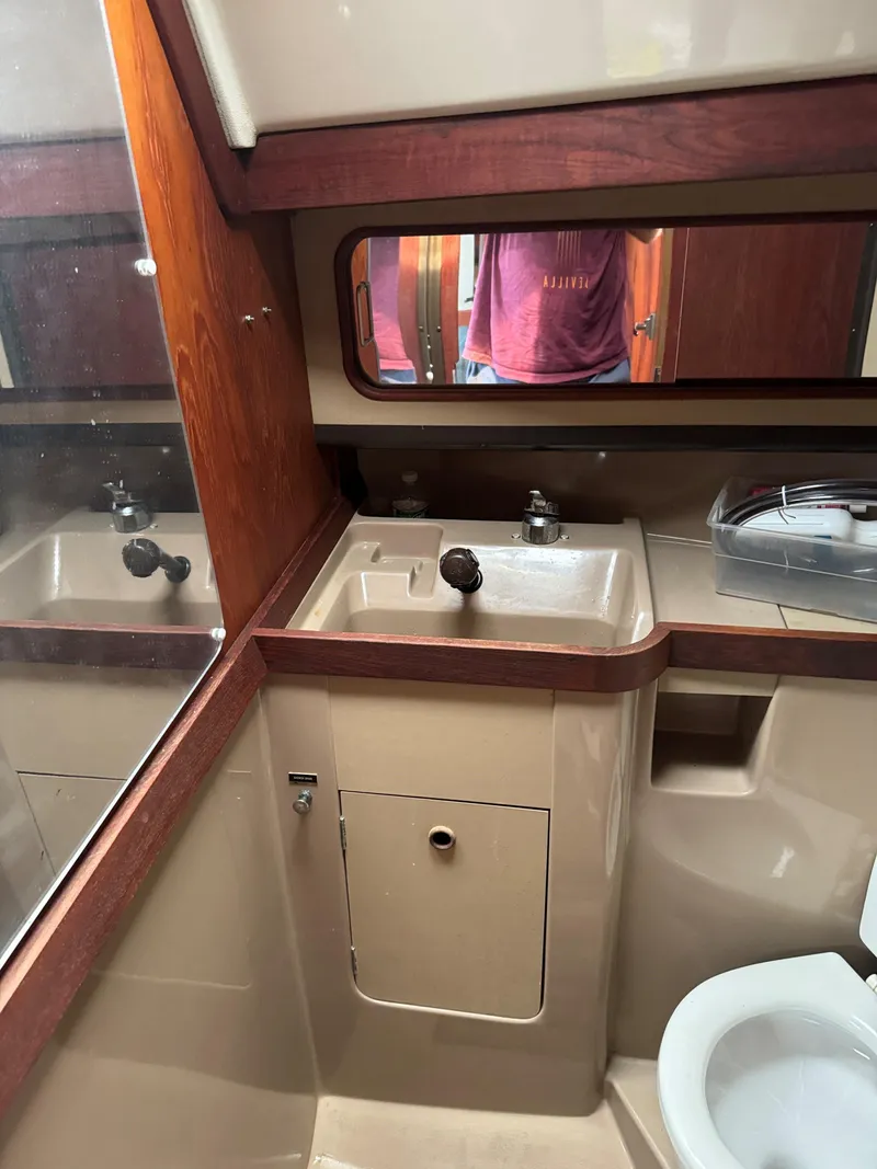 Slide: The Image of 1984 C&C 35 MK III yacht bathroom with sink, mirror, and toilet. - 17