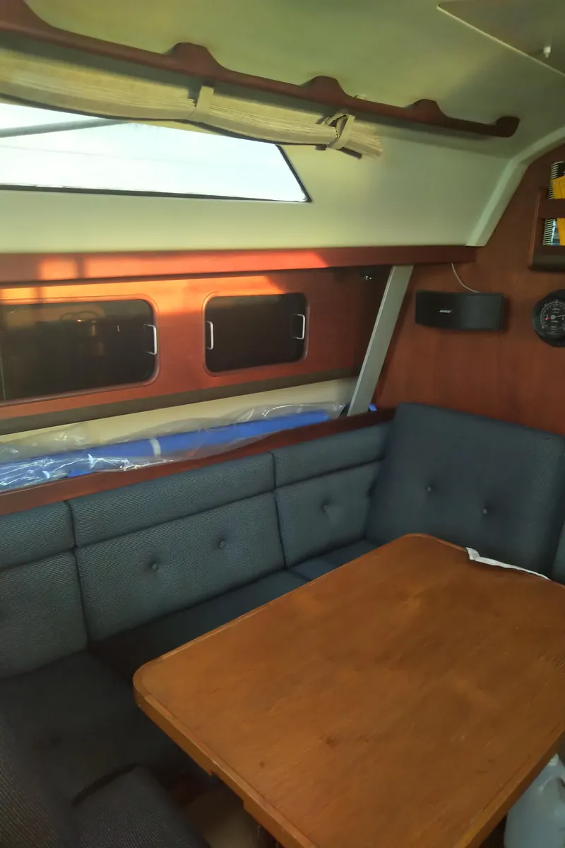 Slide: The Image of Interior of 1984 C&C 35 MK III sailboat with wooden table and cushioned seating. - 18