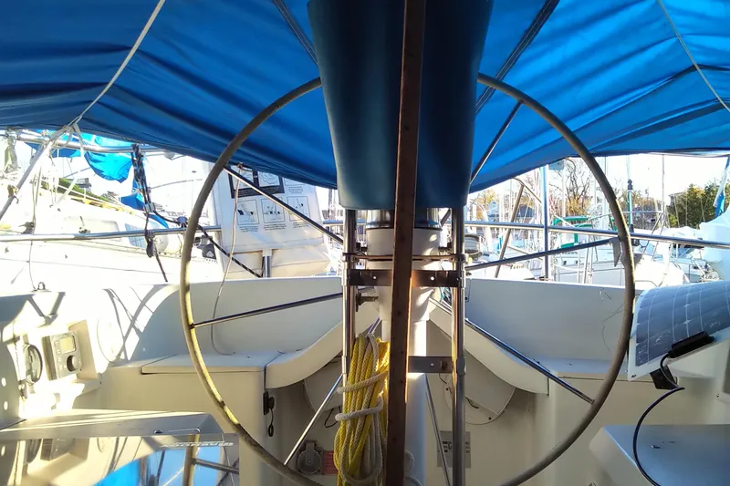 Slide: The Image of 1984 C&C 35 MK III sailboat cockpit with blue canopy and steering wheel. - 19