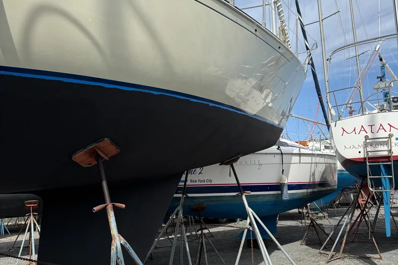 Slide: The Image of Sailboats in a marina, including a 1984 C&C 35 MK III, supported on stands. - 4