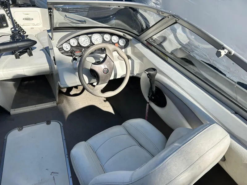 Slide: The Image of 2005 Stingray 195 FX boat interior with steering wheel and dashboard controls. - 12