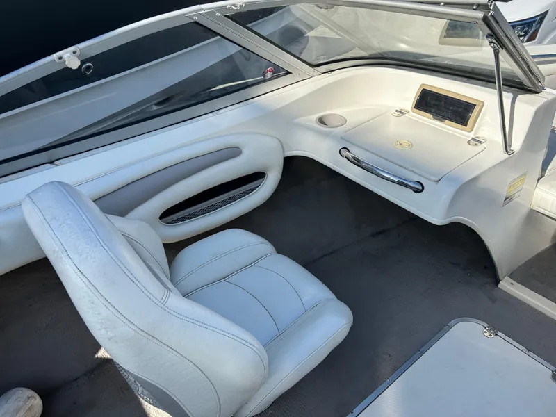 Slide: The Image of 2005 Stingray 195 FX boat interior with white seating and dashboard. - 15