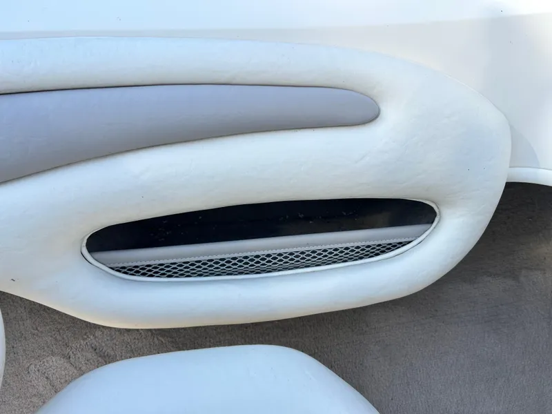 Slide: The Image of Interior detail of a 2005 Stingray 195 FX boat, featuring white and gray upholstery. - 16
