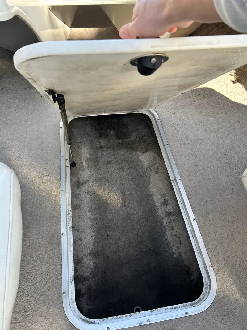 Slide: The Image of Open storage compartment in a 2005 Stingray 195 FX boat interior. - 18