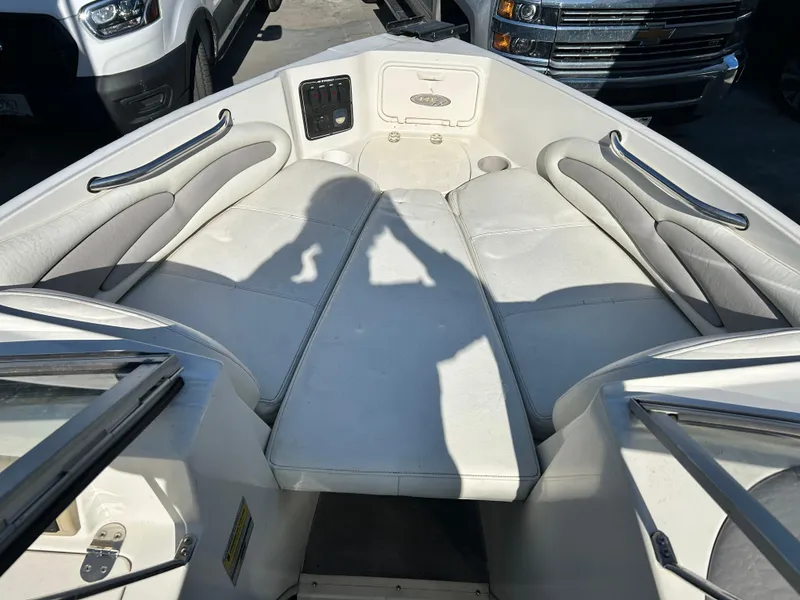 Slide: The Image of 2005 Stingray 195 FX boat interior with white seating and metal handles. - 19