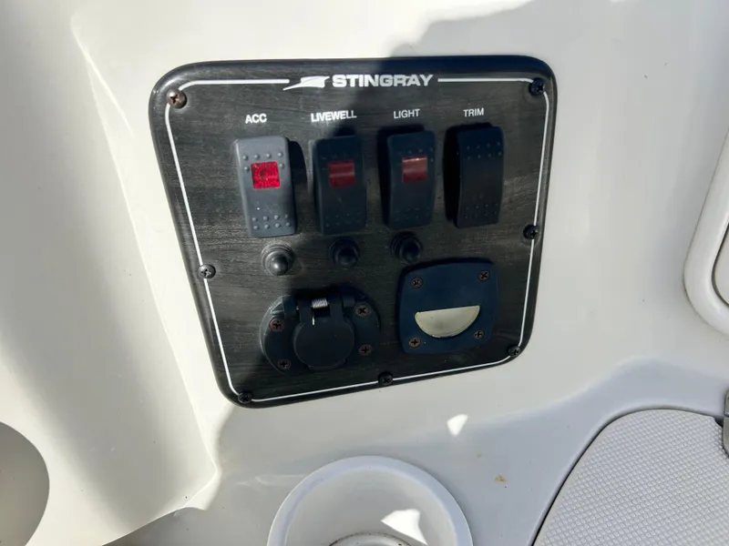 Slide: The Image of Control panel of a 2005 Stingray 195 FX boat with switches for accessories. - 21