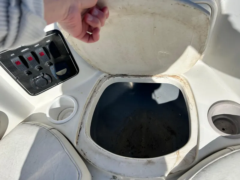 Slide: The Image of 2005 Stingray 195 FX boat interior with open storage compartment and control panel. - 22