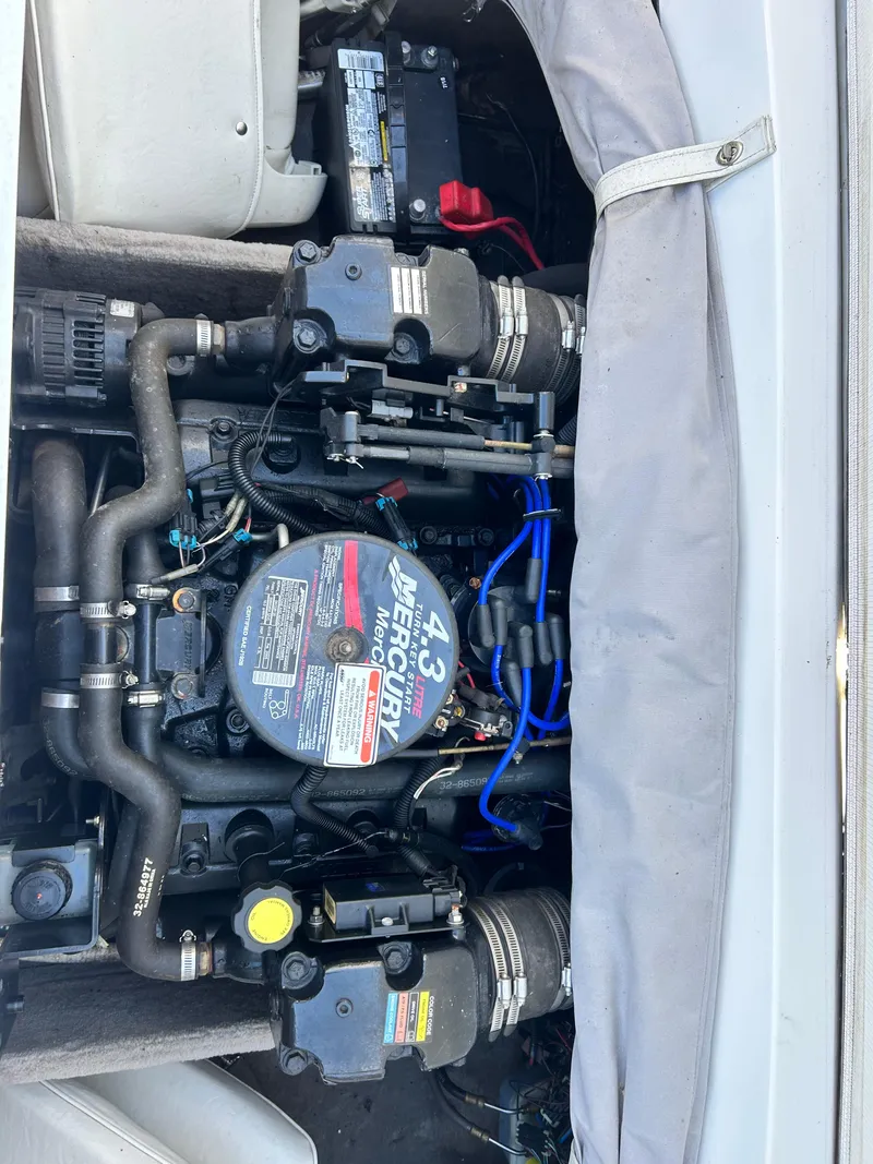 Slide: The Image of Engine compartment of a 2005 Stingray 195 FX boat, featuring a 4.3L Mercury engine. - 23