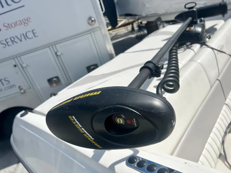 Slide: The Image of Minn Kota trolling motor on a 2005 Stingray 195 FX boat, docked near a service area. - 25