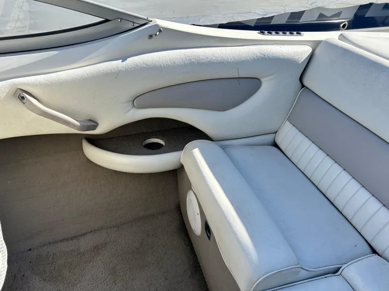 Slide: The Image of 2005 Stingray 195 FX boat interior with white and gray seating and carpeted floor. - 7