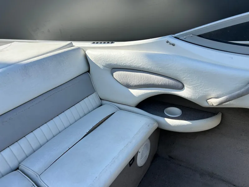 Slide: The Image of 2005 Stingray 195 FX boat interior with white leather seating and cup holder. - 9