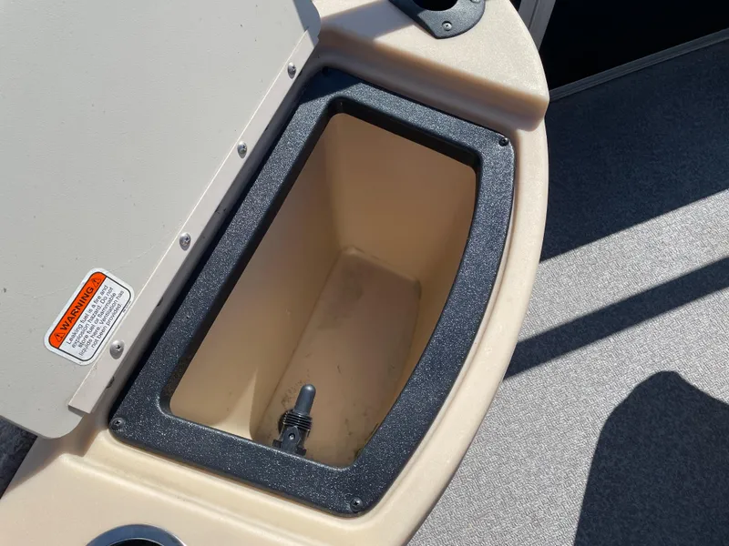 Slide: The Image of Storage compartment on a 2017 Sun Tracker BB18 boat, featuring a beige interior. - 11