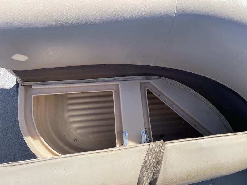 Slide: The Image of 2017 Sun Tracker BB18 boat storage compartment with beige seating. - 13