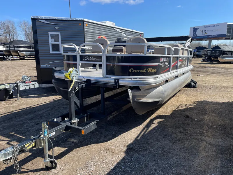 Slide: The Image of 2017 Sun Tracker BB18 pontoon boat on trailer in outdoor storage area. - 3