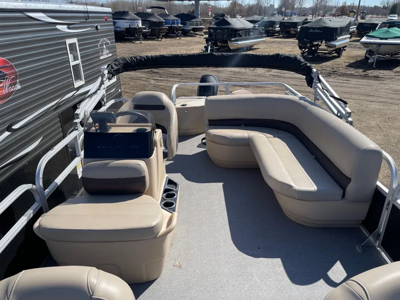 Slide: The Image of 2017 Sun Tracker BB18 pontoon boat with beige seating, docked outdoors. - 5