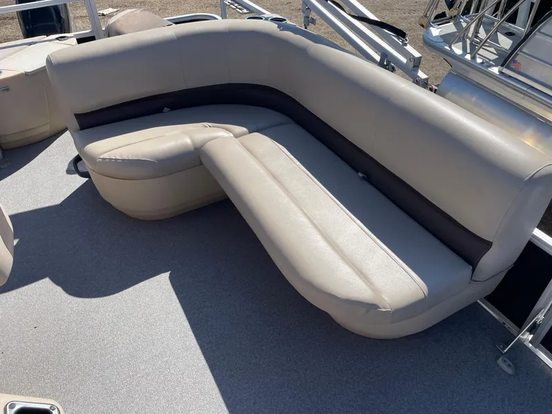 Slide: The Image of 2017 Sun Tracker BB18 boat with beige seating and spacious deck area. - 6