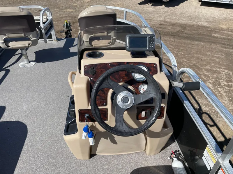 Slide: The Image of 2017 Sun Tracker BB18 boat console with steering wheel and navigation system. - 7