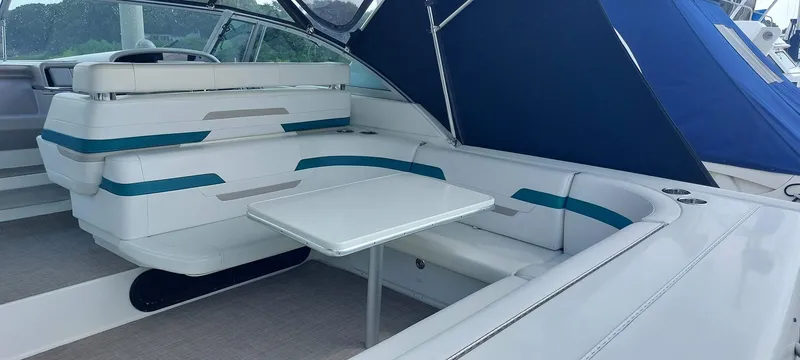 Slide: The Image of 1998 Formula 41 PC yacht interior with white seating and table, featuring blue accents. - 16