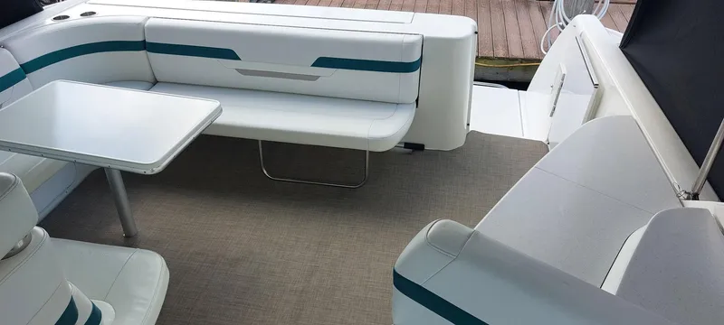 Slide: The Image of 1998 Formula 41 PC boat interior with white seating and table, docked at marina. - 17