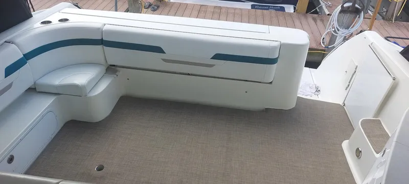 Slide: The Image of 1998 Formula 41 PC boat interior with white seating and carpeted floor. - 18