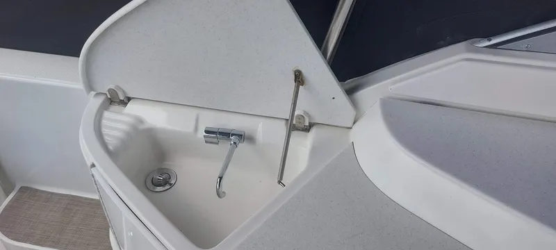 Slide: The Image of 1998 Formula 41 PC boat sink with faucet and storage compartment. - 19