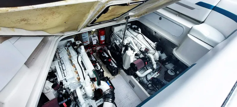 Slide: The Image of Engine compartment of a 1998 Formula 41 PC boat, showcasing dual engines and equipment. - 21