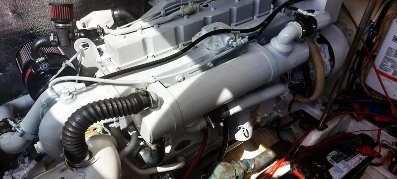 Slide: The Image of Engine compartment of a 1998 Formula 41 PC boat, showcasing mechanical components and wiring. - 23