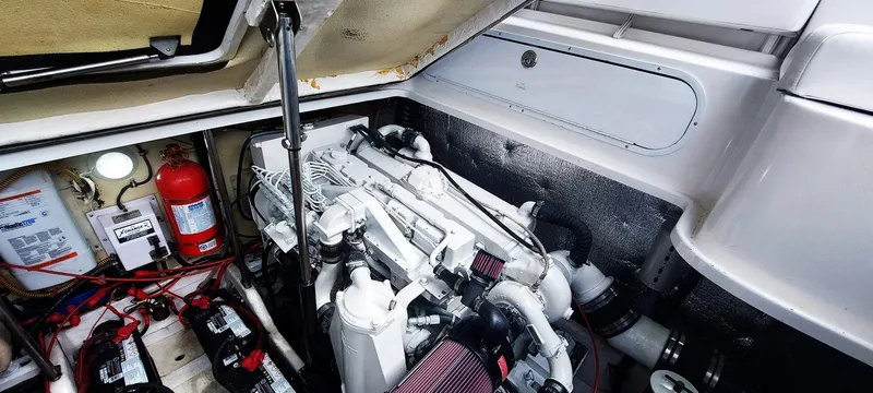 Slide: The Image of Engine compartment of a 1998 Formula 41 PC boat, featuring batteries and fire extinguisher. - 24