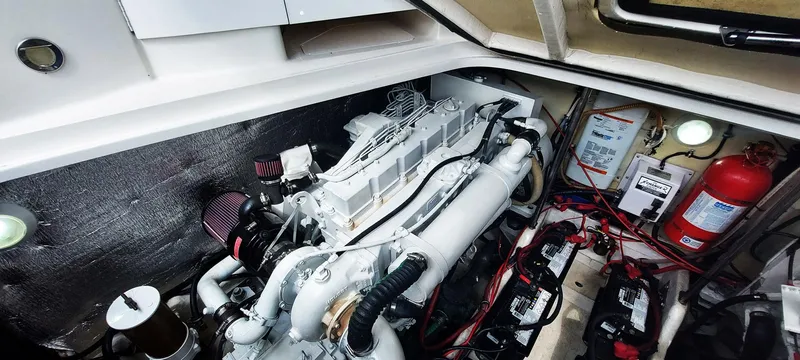 Slide: The Image of Engine compartment of a 1998 Formula 41 PC boat, featuring batteries and fire extinguisher. - 25