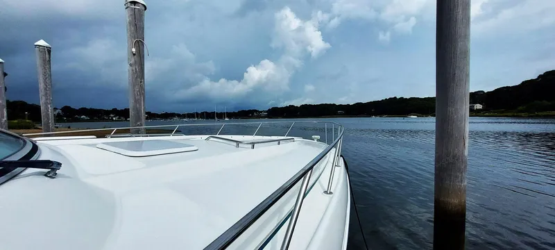Slide: The Image of 1998 Formula 41 PC yacht docked by calm waters under a cloudy sky. - 28
