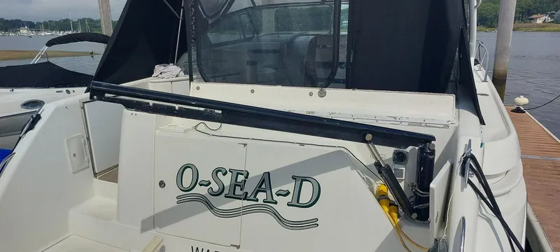 Slide: The Image of 1998 Formula 41 PC boat docked, featuring "O-SEA-D" name on the stern. - 35