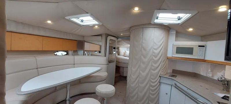 Slide: The Image of 1998 Formula 41 PC yacht interior with modern seating, table, and kitchenette. - 5