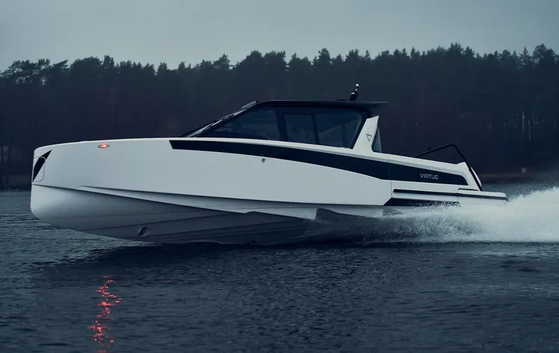 Slide: The Image of 2025 Virtue V10Top boat cruising on a lake with forest backdrop. - 10