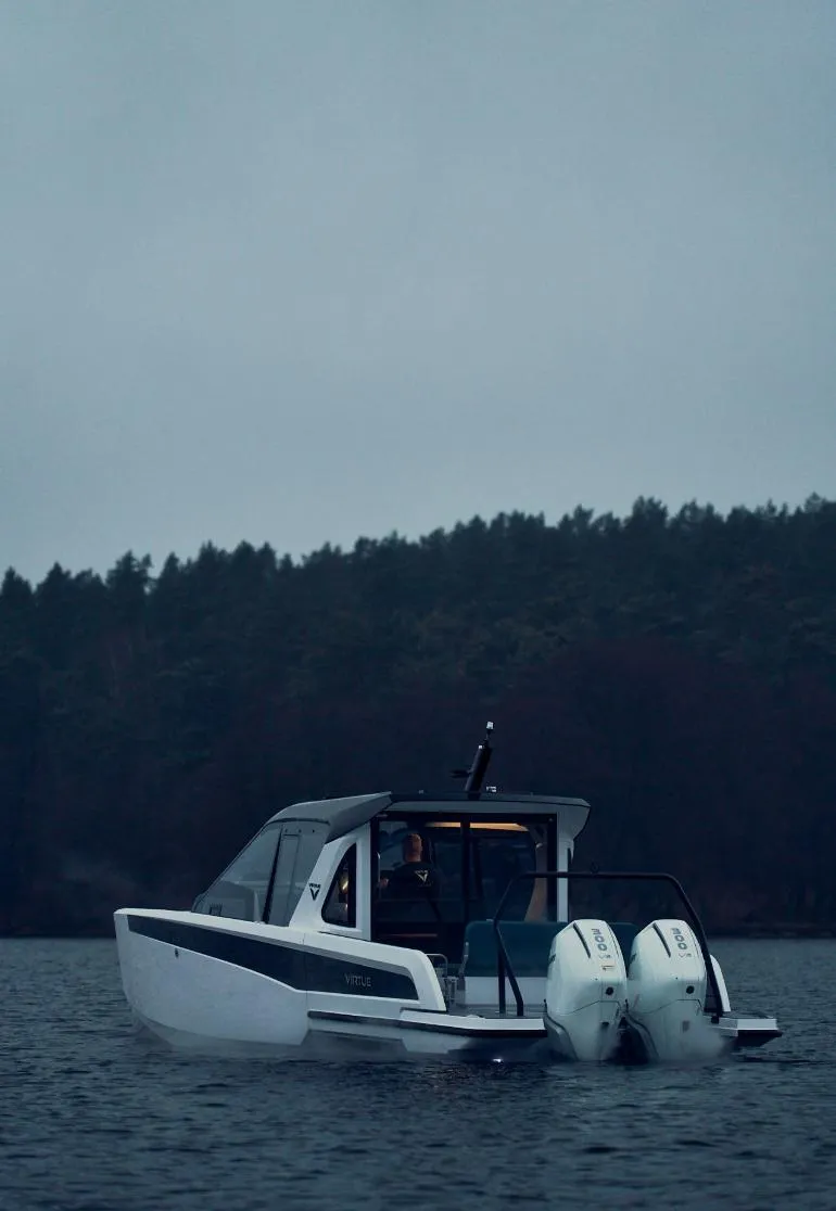 Slide: The Image of Virtue V10Top 2025 boat on a lake with forested background. - 11