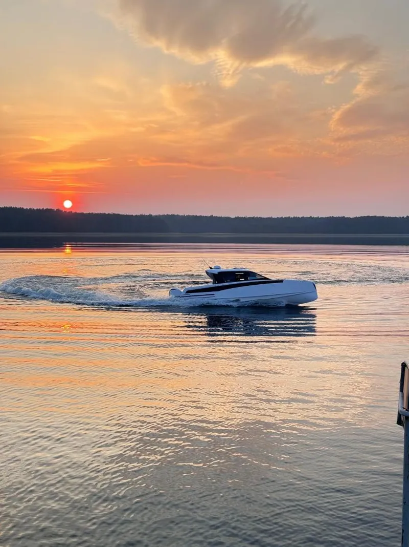 Slide: The Image of Luxury Virtue V10Top boat cruising at sunset on serene waters, 2025 model. - 13