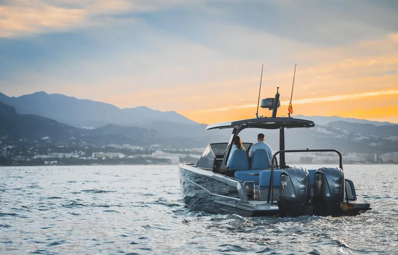 Slide: The Image of 2025 Virtue V10Top boat cruising at sunset with mountains in the background. - 3