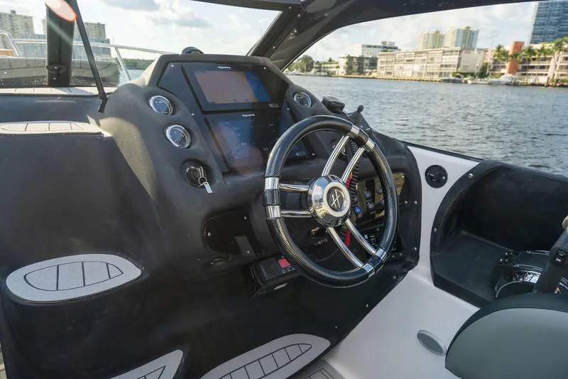 Slide: The Image of Helm of 2025 Hanover 305 boat with modern controls and waterfront view. - 4