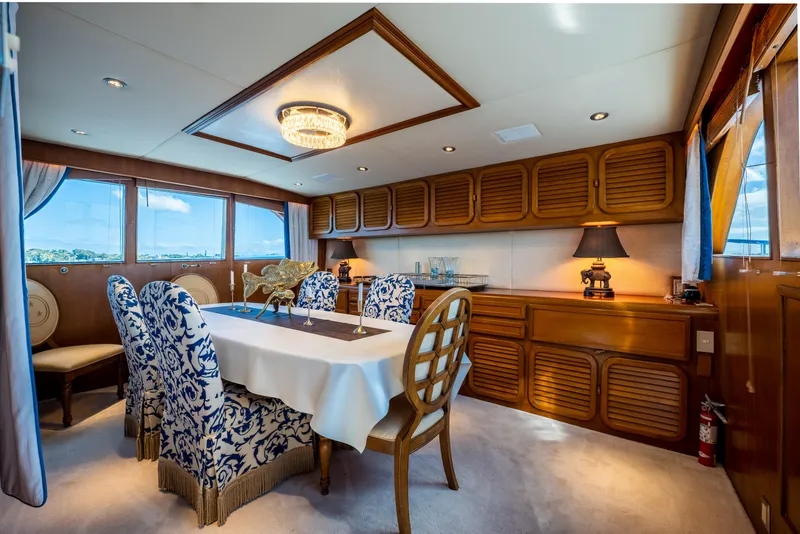 Slide: The Image of Luxurious dining area in a 1985 Cheoy Lee 90 Motor Yacht with elegant decor. - 13