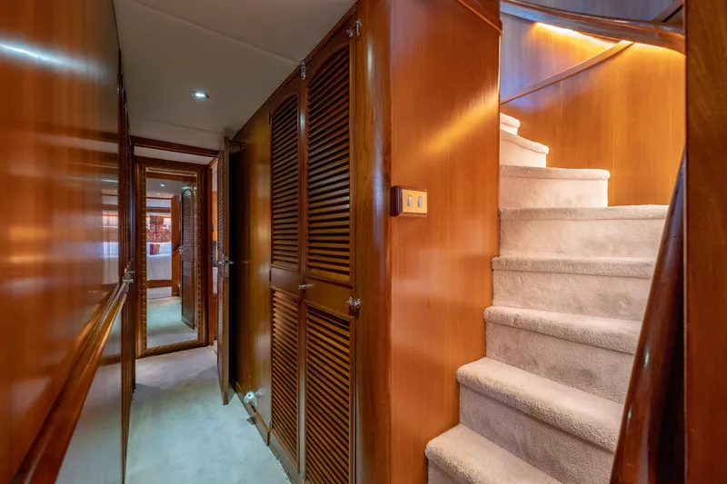Slide: The Image of Interior hallway of 1985 Cheoy Lee 90 Motor Yacht with wooden paneling and carpeted stairs. - 18
