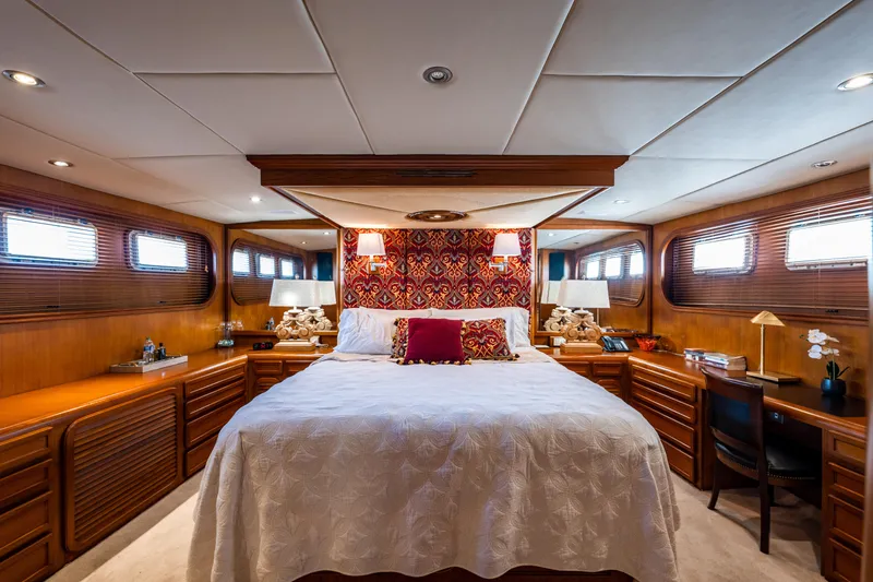 Slide: The Image of Luxurious bedroom interior of 1985 Cheoy Lee 90 Motor Yacht with elegant wood paneling. - 20