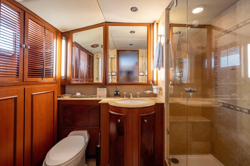 Slide: The Image of Luxurious bathroom in 1985 Cheoy Lee 90 Motor Yacht with wood accents and glass shower. - 22