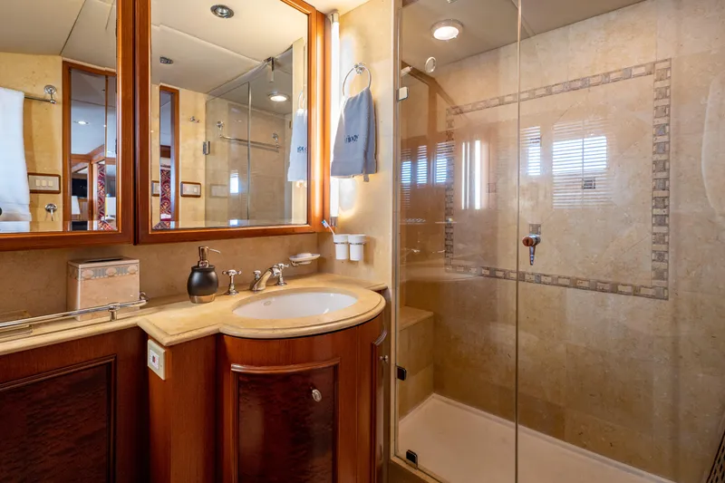 Slide: The Image of Luxurious bathroom in 1985 Cheoy Lee 90 Motor Yacht with glass shower and wooden cabinetry. - 23