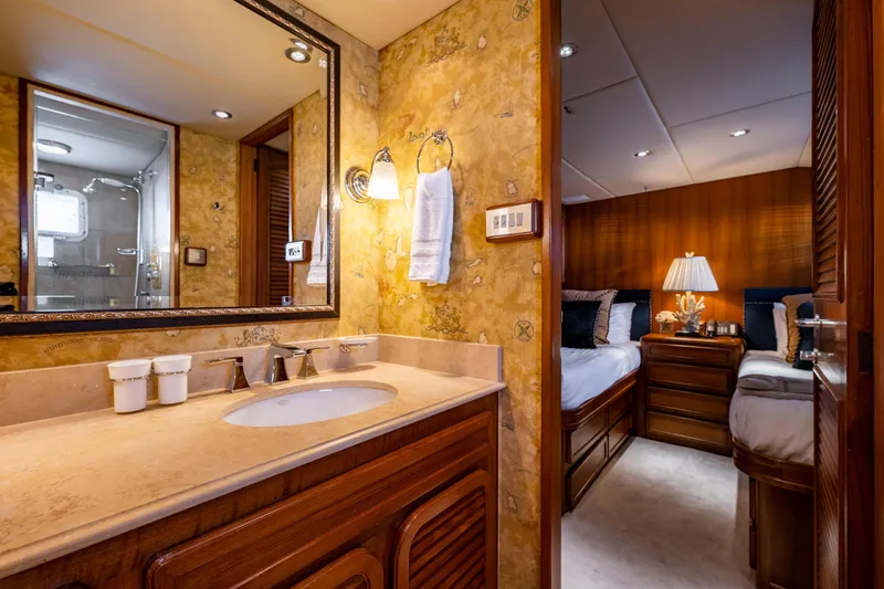 Slide: The Image of Luxurious 1985 Cheoy Lee 90 Motor Yacht interior with elegant bathroom and cozy bedroom. - 26