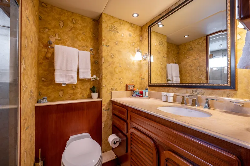 Slide: The Image of Luxurious bathroom in 1985 Cheoy Lee 90 Motor Yacht with elegant wood cabinetry and large mirror. - 27