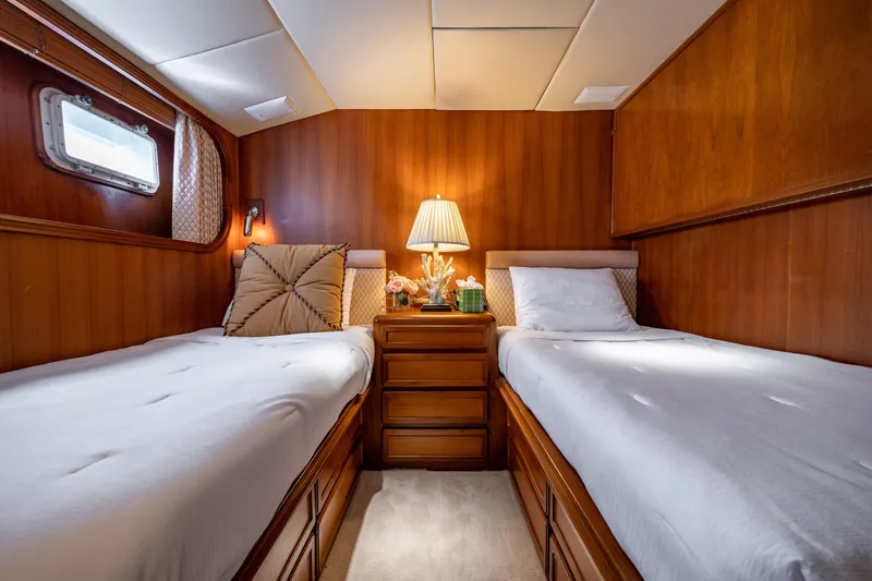 Slide: The Image of Twin cabin interior of 1985 Cheoy Lee 90 Motor Yacht with wooden decor. - 28