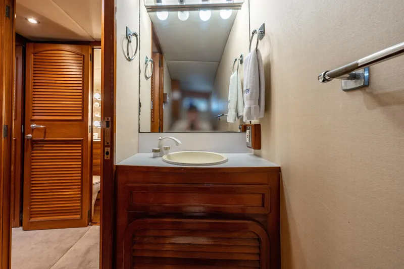 Slide: The Image of 1985 Cheoy Lee 90 Motor Yacht bathroom with wooden cabinetry and mirror. - 35
