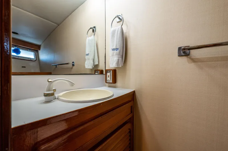 Slide: The Image of 1985 Cheoy Lee 90 Motor Yacht bathroom with wooden vanity and mirror. - 36